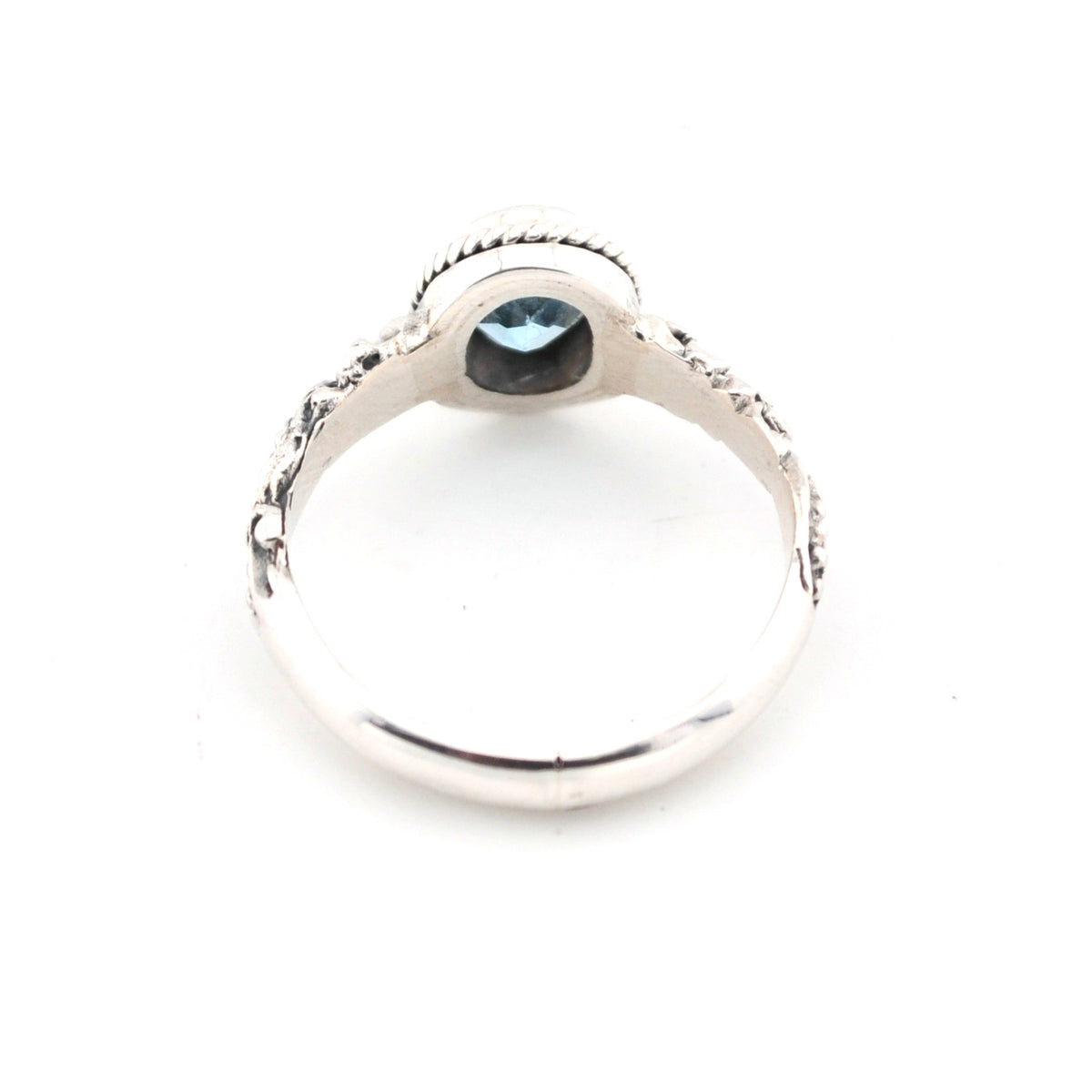 Silver ring with a dark gemstone on a white background