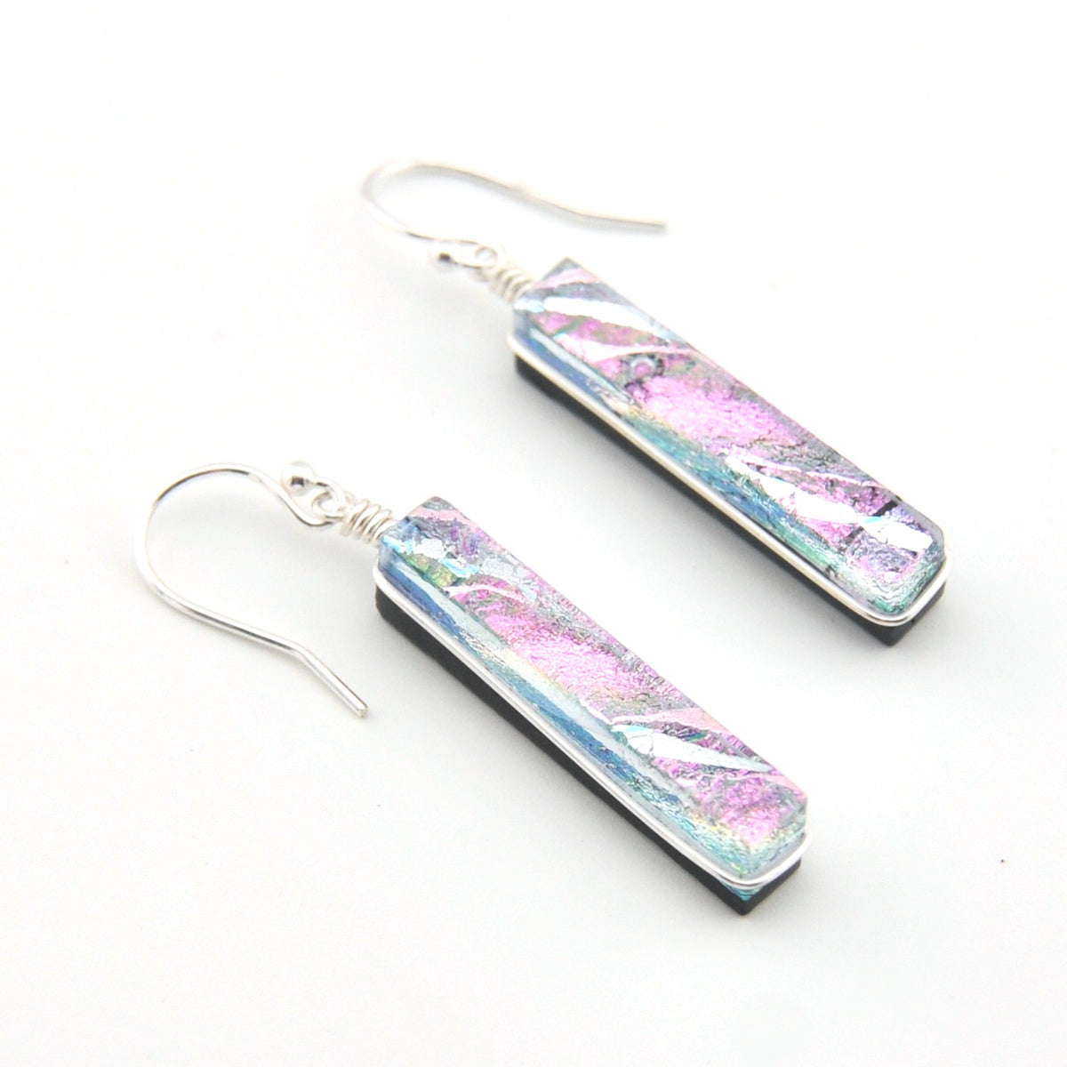 Pair of earrings with colorful bar design on a white background