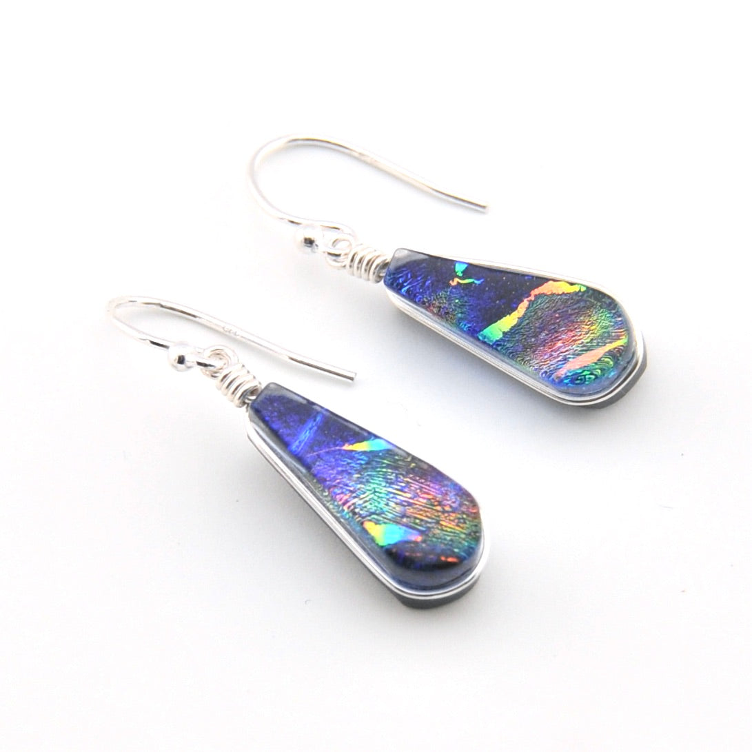 Teardrop-shaped earrings with multicolored iridescent finish on a white background