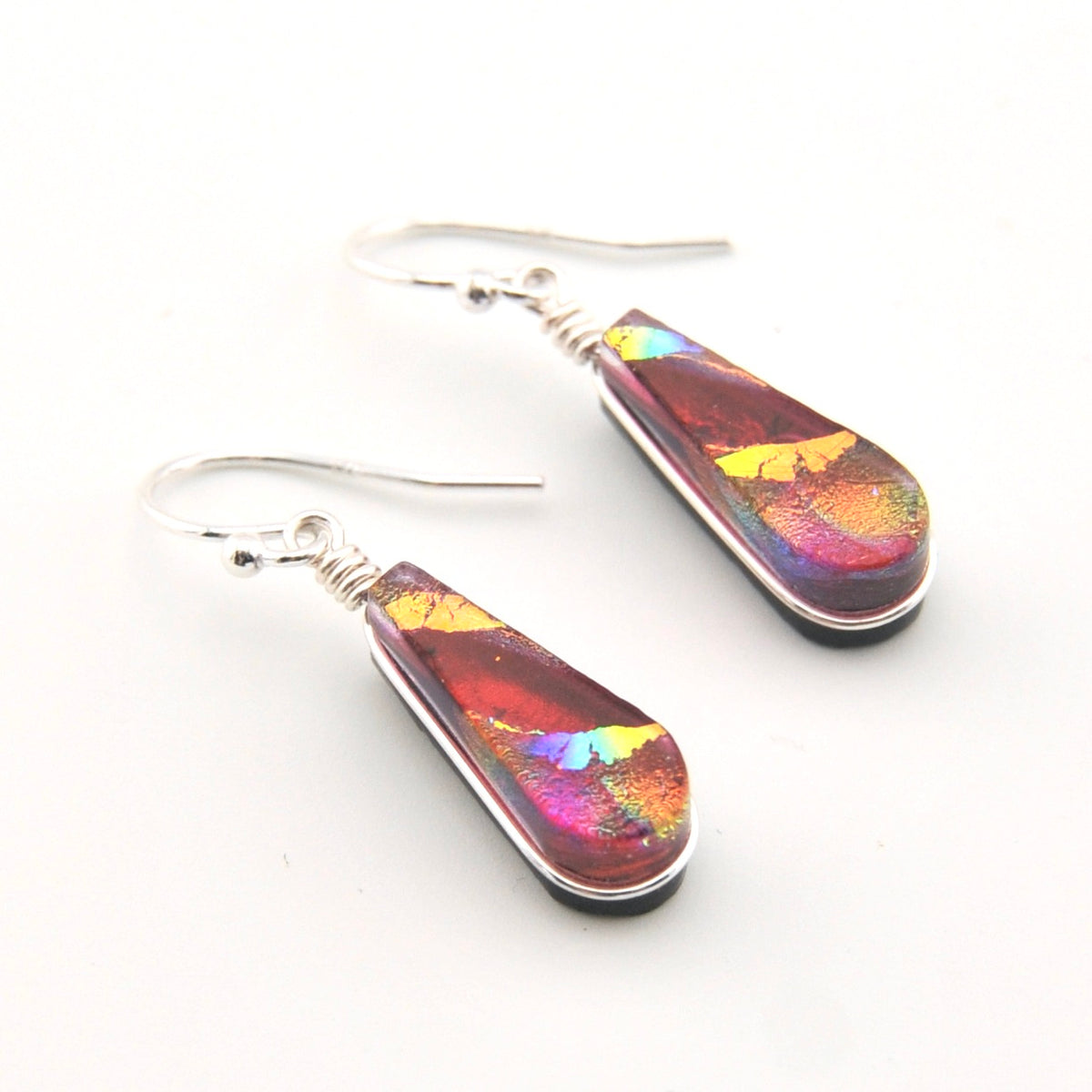 Multicolored teardrop earrings on a white background