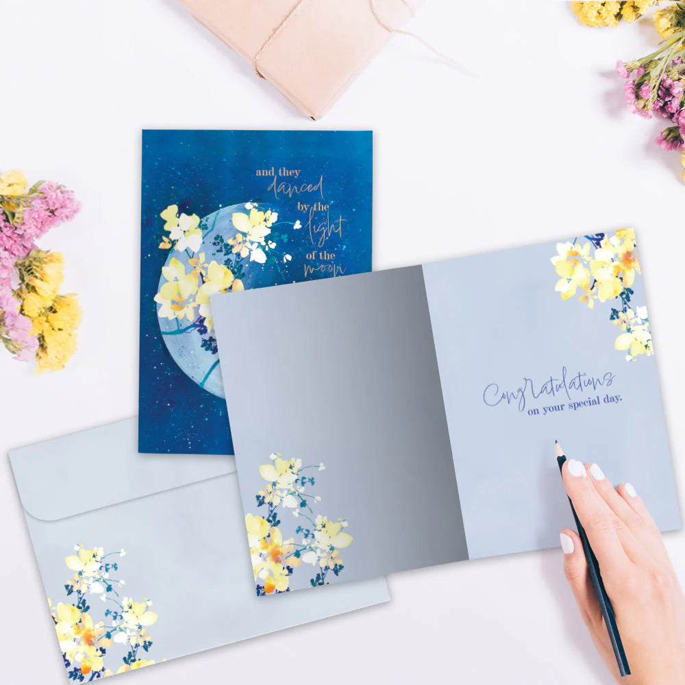 Floral card with envelope on a light surface