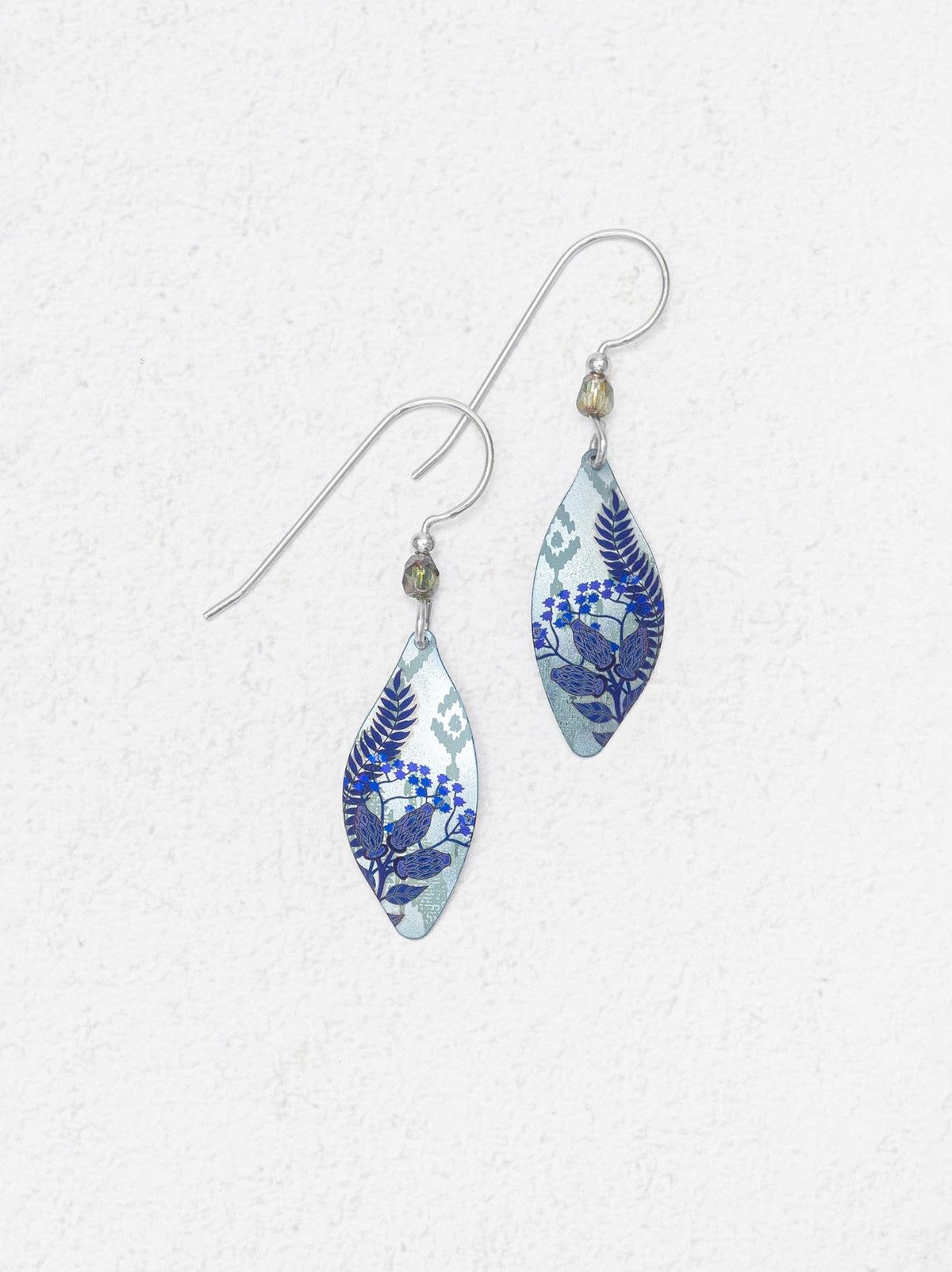 Pair of blue floral earrings on a white background