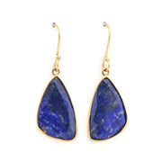 Gold earrings with blue stone drops on a white background