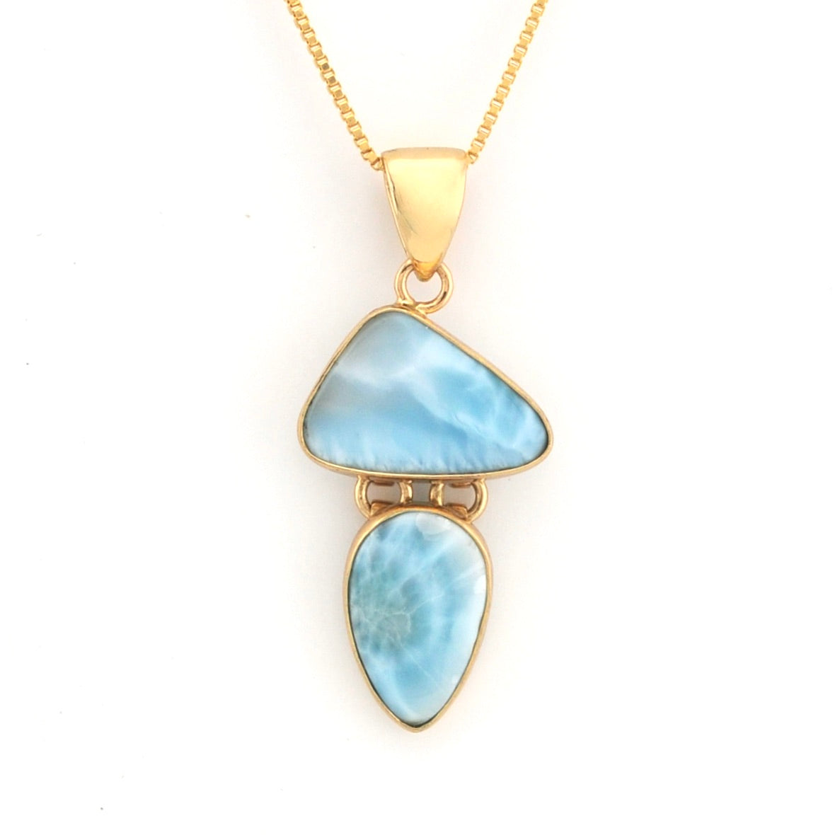 Gold necklace with a pendant featuring two blue stones on a white background