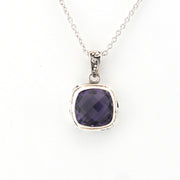 Silver necklace with a purple gemstone pendant on a white background