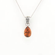 Teardrop-shaped citrine pendant on a silver chain against a white background