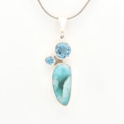 Jewelry pendant with blue stones on a white background