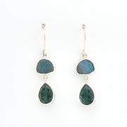 Pair of earrings with green teardrop-shaped stones on a white background