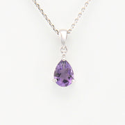 Purple teardrop-shaped gemstone pendant on a white background