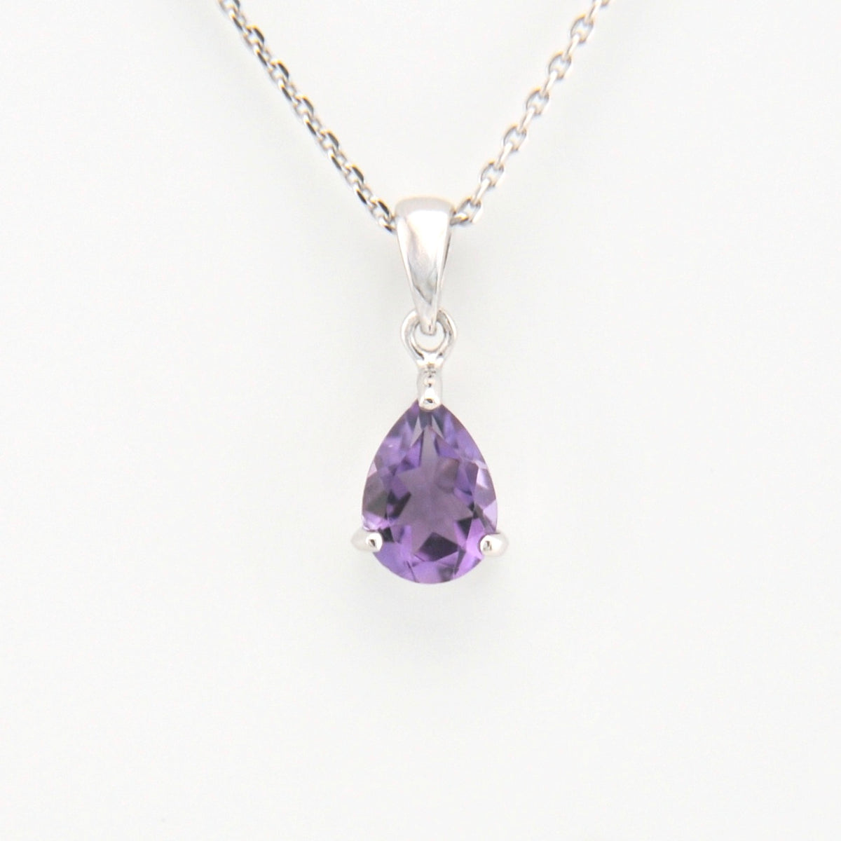 Purple teardrop-shaped gemstone pendant on a white background
