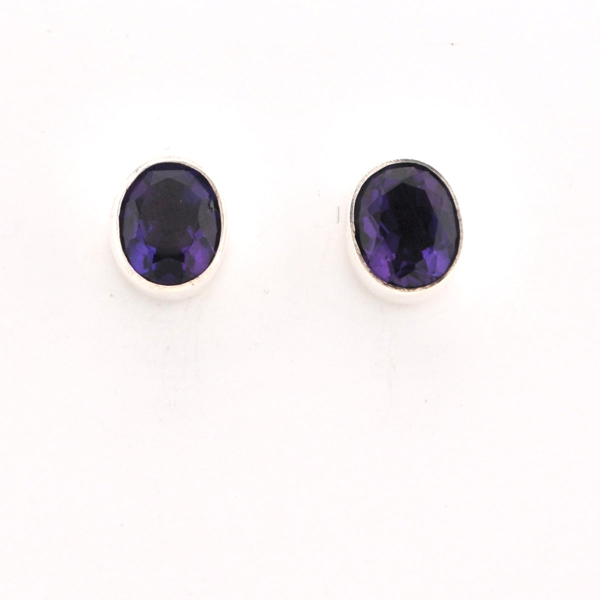 Pair of purple gemstone stud earrings on a white background
