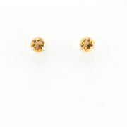 Pair of citrine round stud earrings on a white background