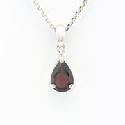 Teardrop-shaped gemstone pendant on a white background