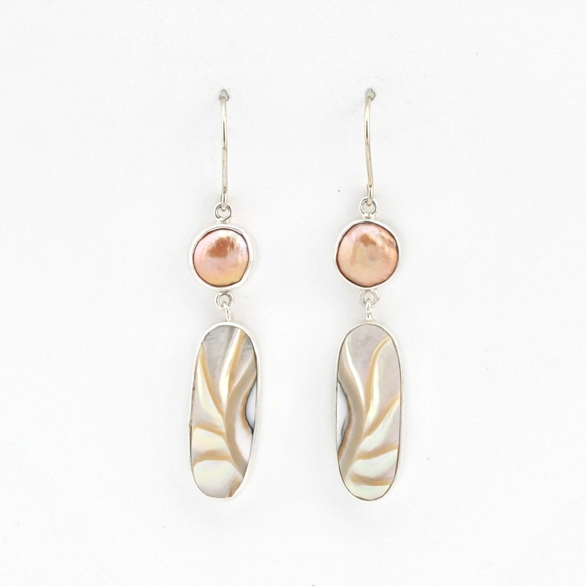 Pair of earrings with pink and beige stones on a white background
