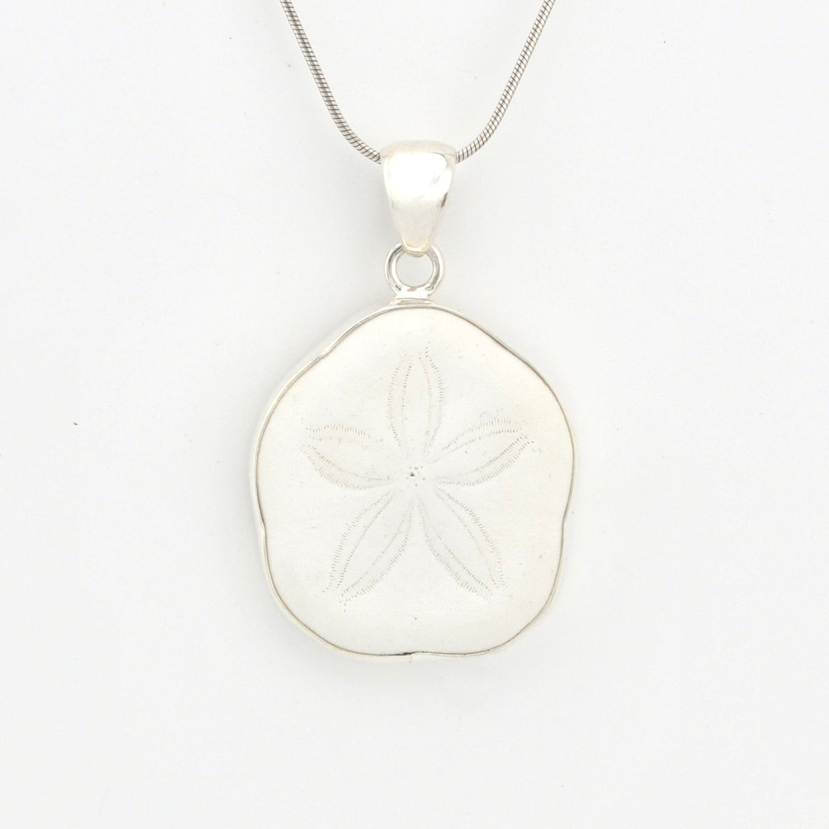 Silver sand dollar pendant on a white background
