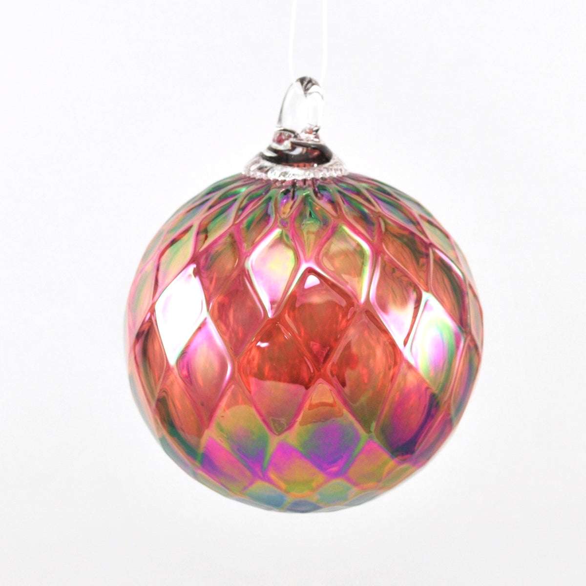 Multicolored glass ornament with geometric pattern on a white background