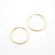 Gold hoop earrings on a white background