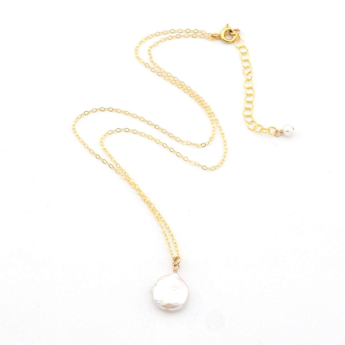 Gold necklace with a white pearl pendant on a white background