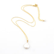 Gold necklace with a white pearl pendant on a white background