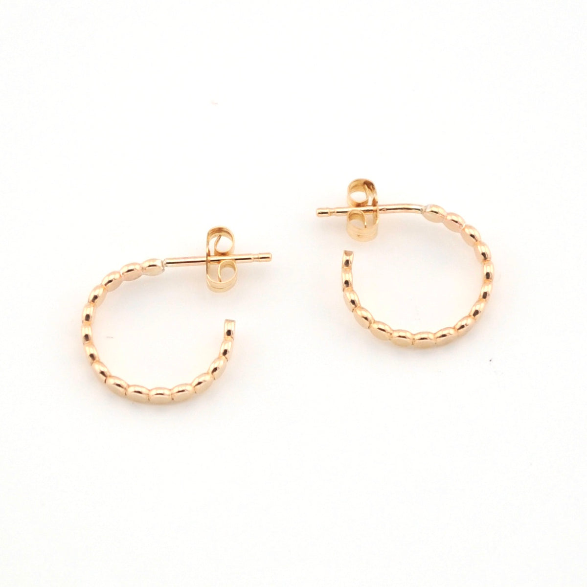 Gold hoop earrings on a white background