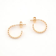 Gold hoop earrings on a white background