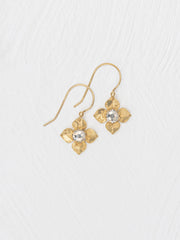 Gold flower-shaped earrings with clear gemstones on a white background