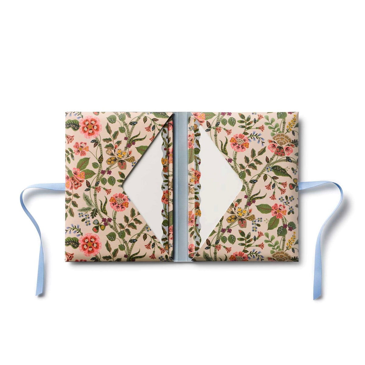 Floral-patterned notebook with ribbon on a white background