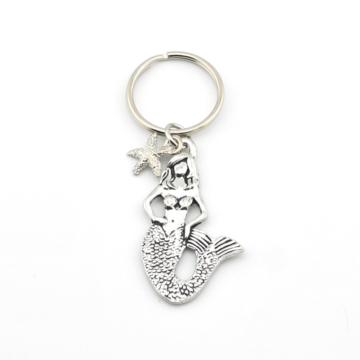 Silver mermaid keychain with starfish charm on a white background