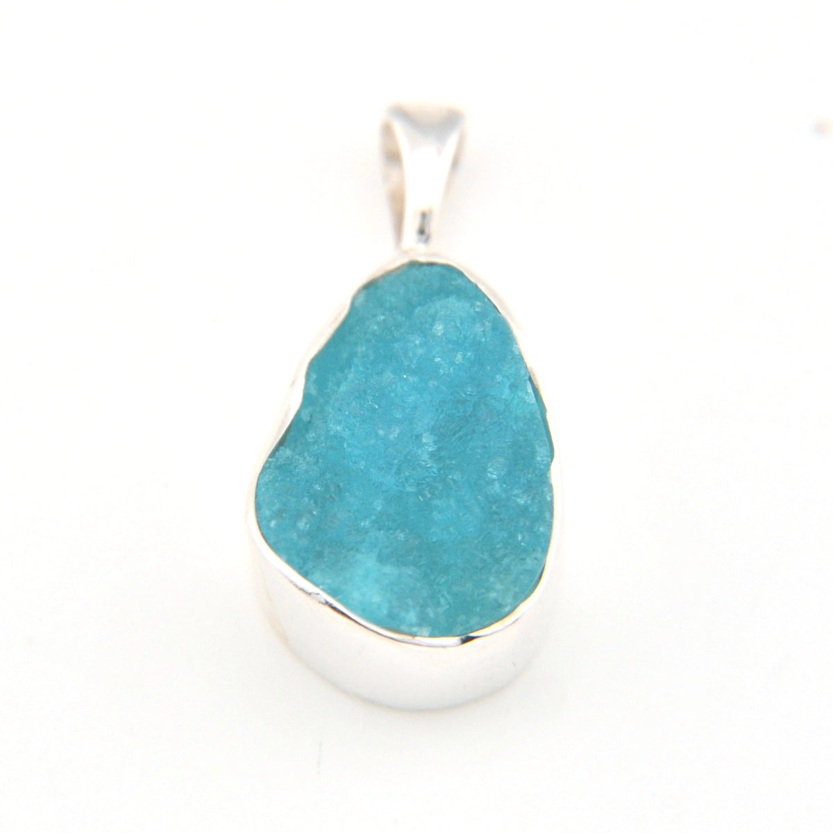 Hemimorphite pendant with silver setting on a white background