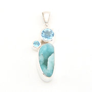 Jewelry pendant with blue stones on a white background
