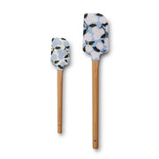 Two floral-patterned spatulas with wooden handles on a white background