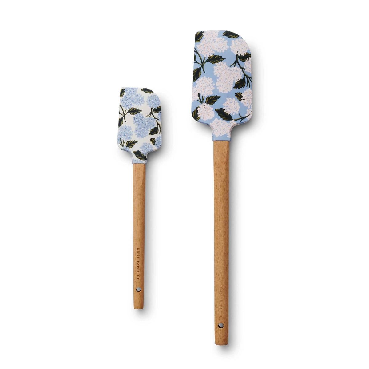 Two floral-patterned spatulas with wooden handles on a white background