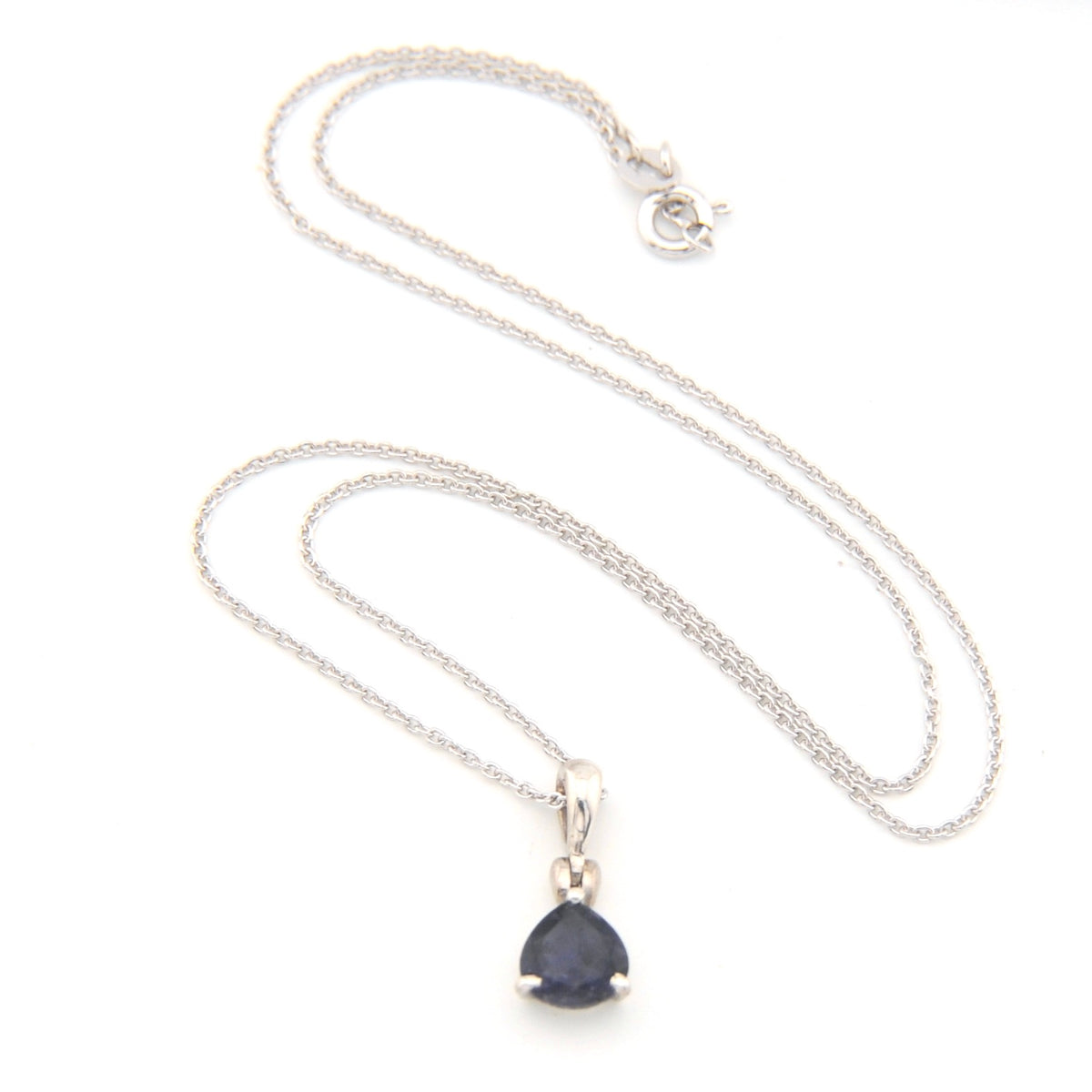 Silver necklace with a deep blue violet teardrop pendant on a white background