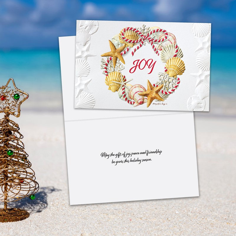 Christmas card with candy cane and shell design on a beach background
