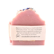 Pink soap bar with a label on a white background