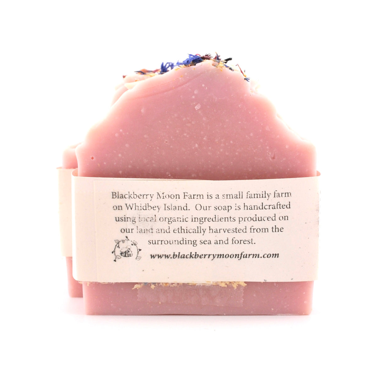 Pink soap bar with a label on a white background