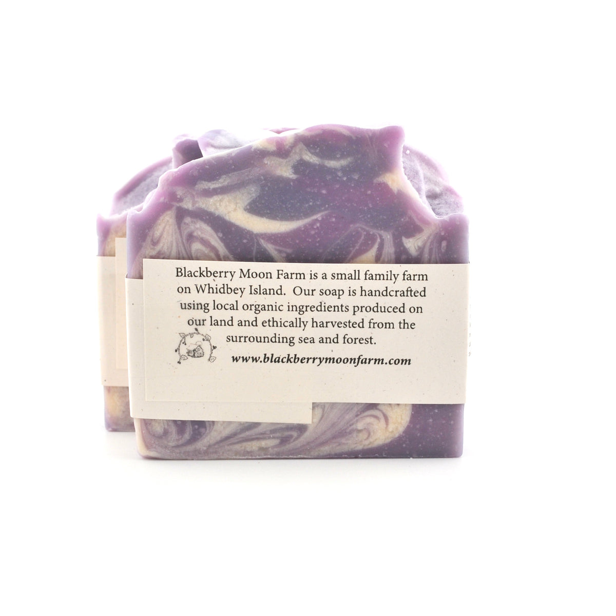 Handcrafted soap bar with a label on a white background