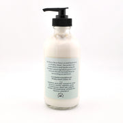 Bottle of cream with a pump on a white background