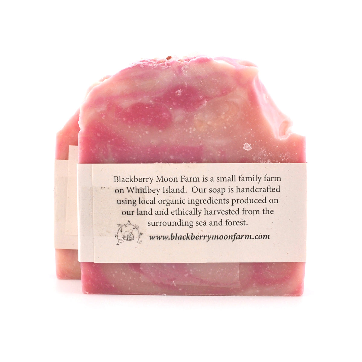Pink soap bar with a label on a white background