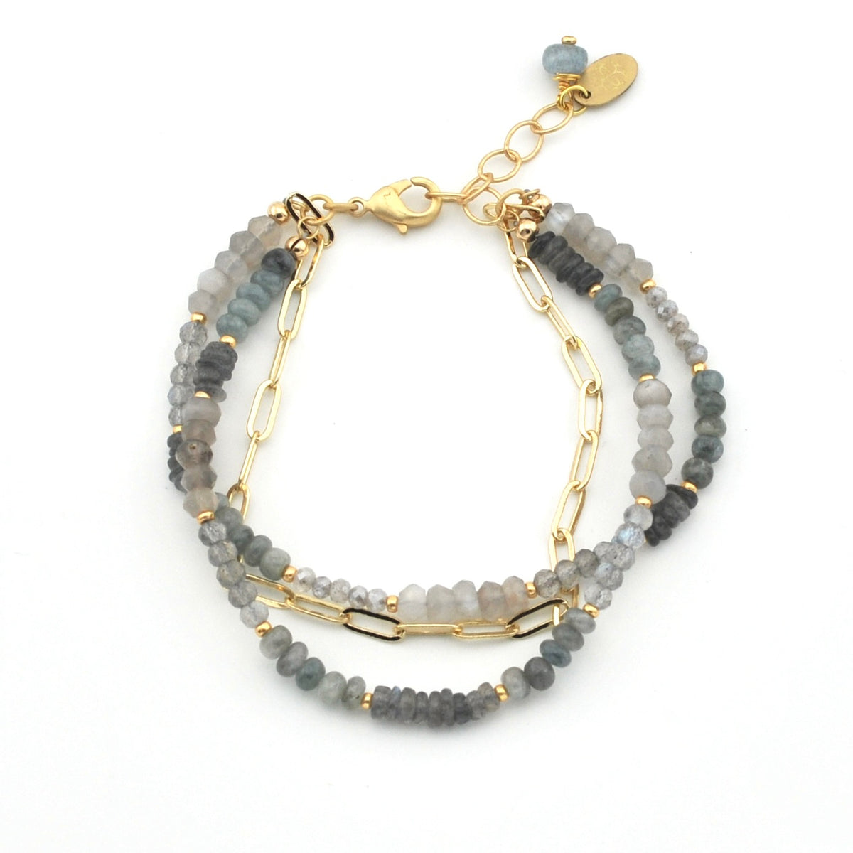 A multi-strand beaded bracelet featuring gray and blue-gray stone beads accented by gold-tone chain links, a lobster clasp, and a small dangling charm on a white background.