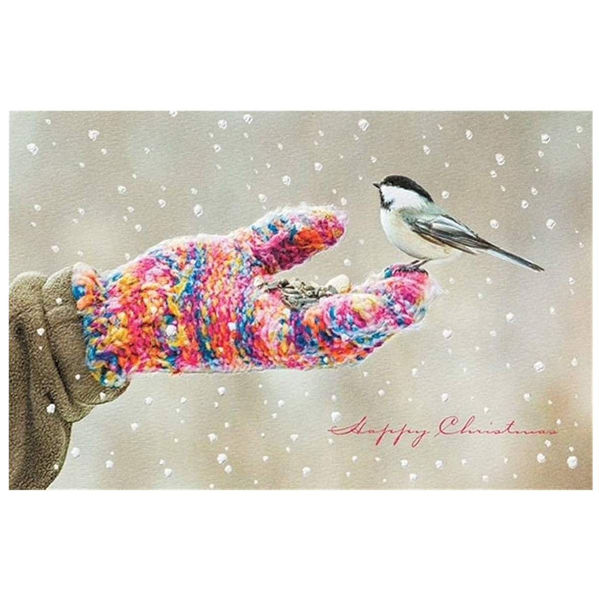 A square art print or card featuring a hand wearing a bright multicolor knitted glove, offering birdseed to a small black-and-white chickadee in falling snow. The words 'Happy Christmas' are written in red script in the lower right corner.