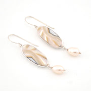 Pair of earrings with shell and pearl drop on a white background