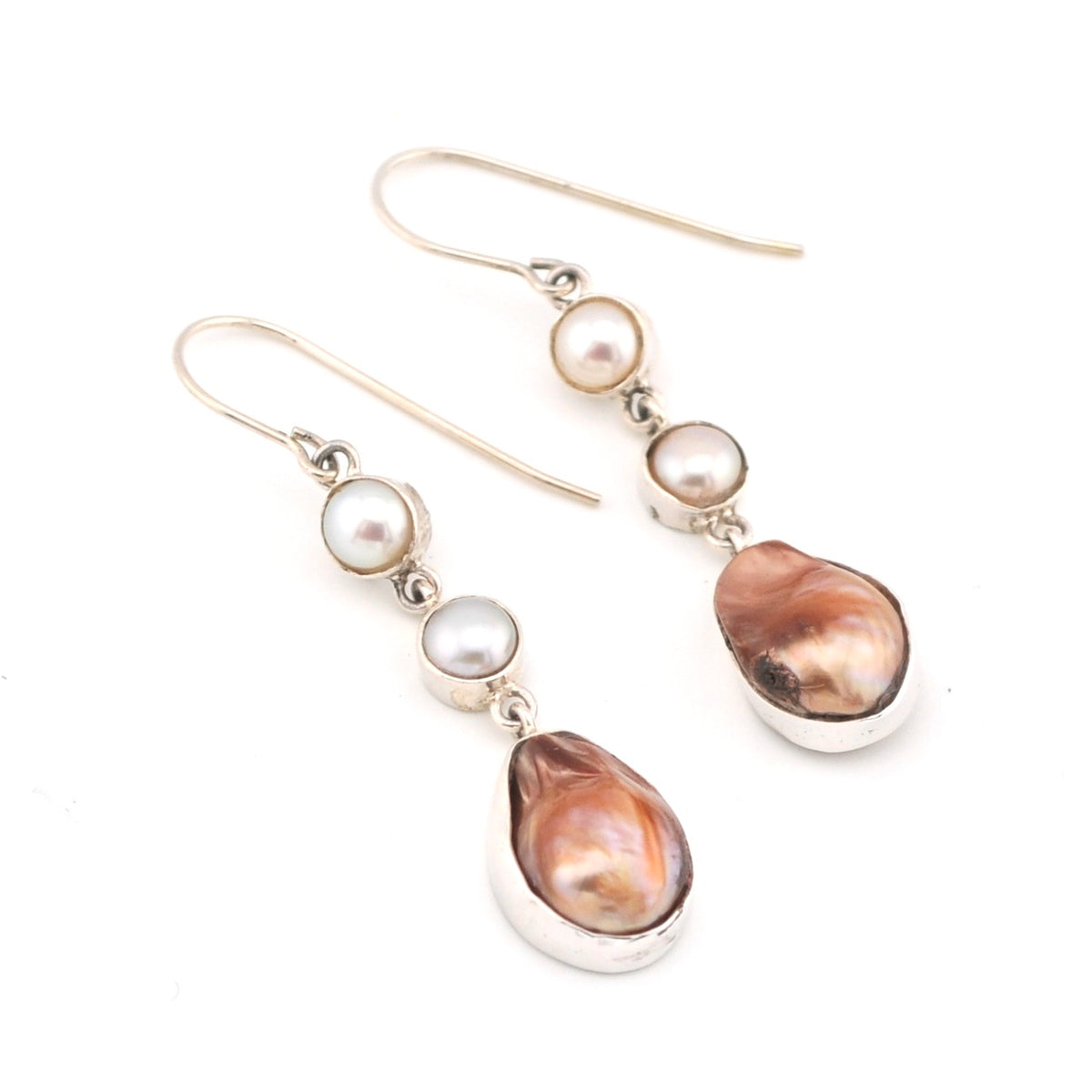 Pair of earrings with pearls and brown teardrop-shaped stones on a white background