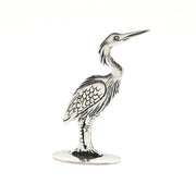 Silver heron figurine on a white background