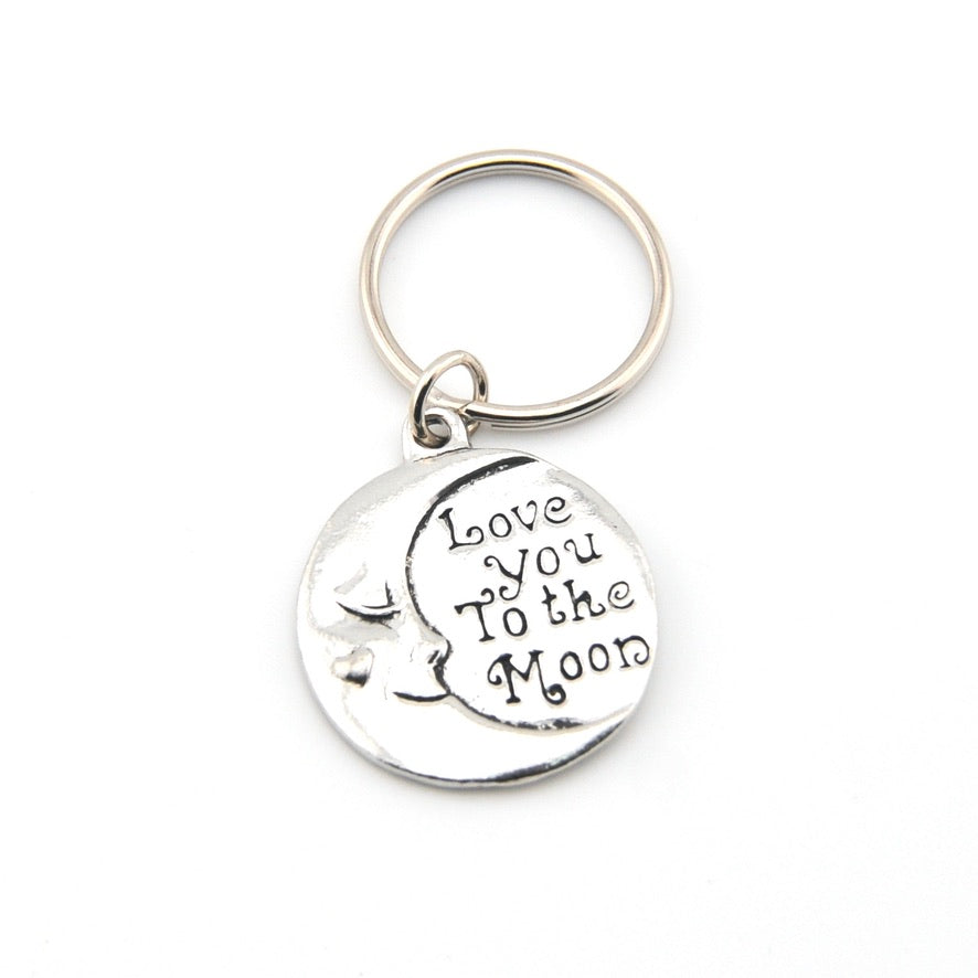 Silver keychain with 'Love You to the Moon' text on a white background