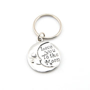 Silver keychain with 'Love You to the Moon' text on a white background