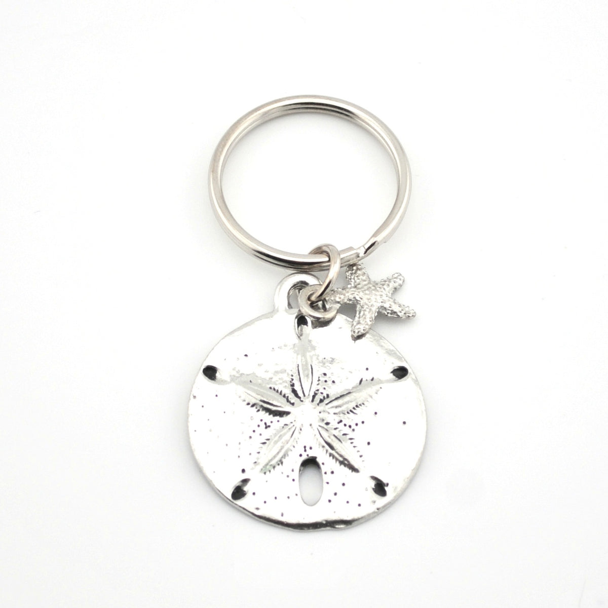 Silver keychain with sand dollar and starfish charms on a white background