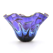 A purple and blue swirled glass bowl with a flared, scalloped rim and gold-toned edging, shown on a white background.