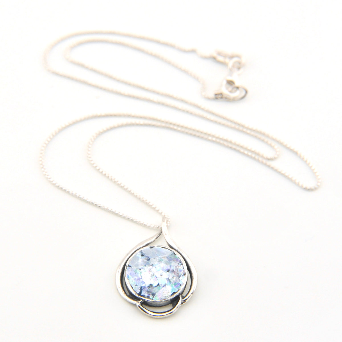 Necklace with a pendant featuring a blue gemstone on a white background