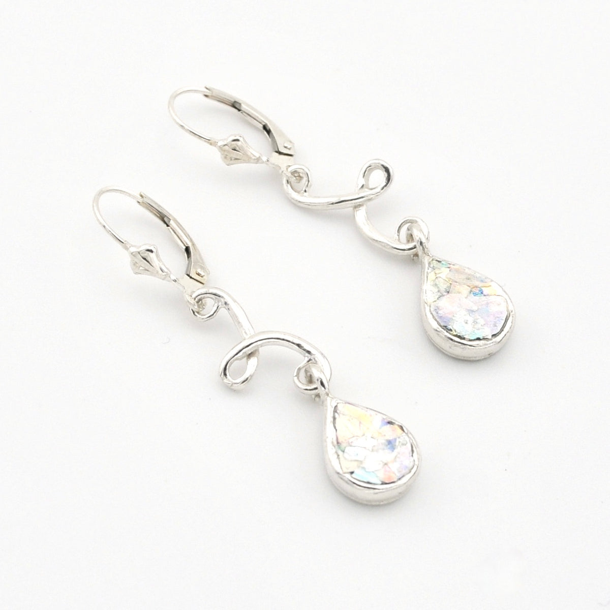 Silver teardrop earrings with Roman glass on a white background